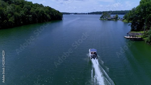 An aerial of a pontoon boat cruising through the Narrows at Lake Martin