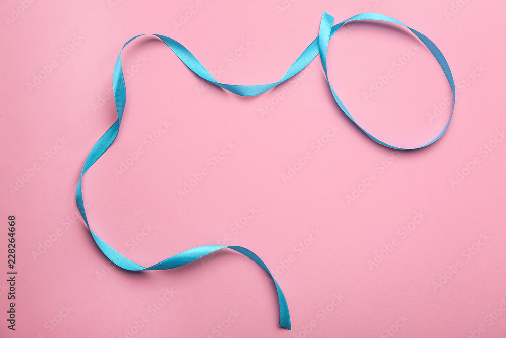 Curled blue ribbon on color background Curled blue ribbon on color background