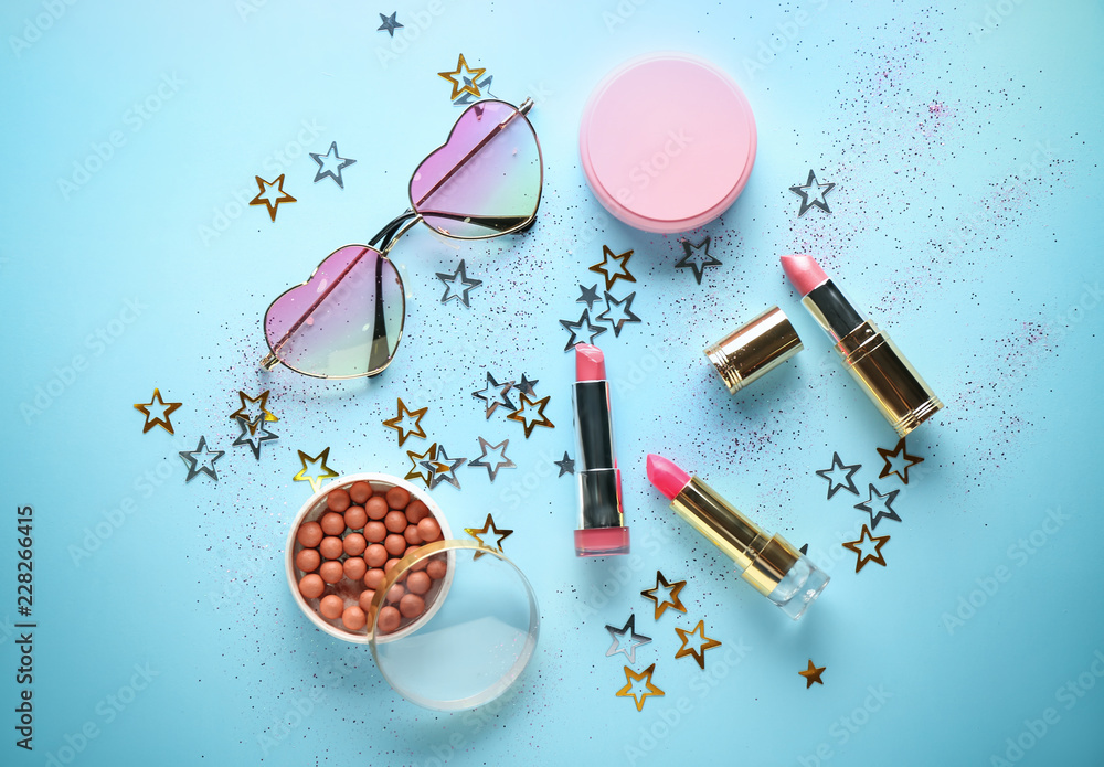 Obraz premium Set of decorative cosmetics with sunglasses on color background