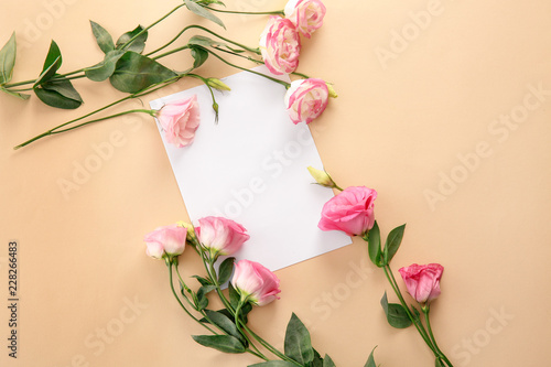 Fototapeta Naklejka Na Ścianę i Meble -  Composition with blank greeting card and beautiful flowers on color background