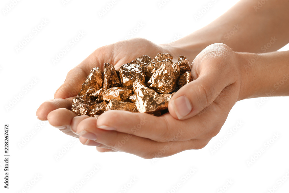 Female hands with gold nuggets on white background Female hands with gold nuggets on white background