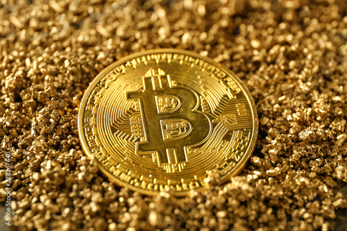 Bitcoin on gold nuggets, closeup