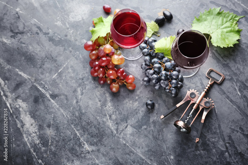 Composition with wine and fresh grapes on grey background