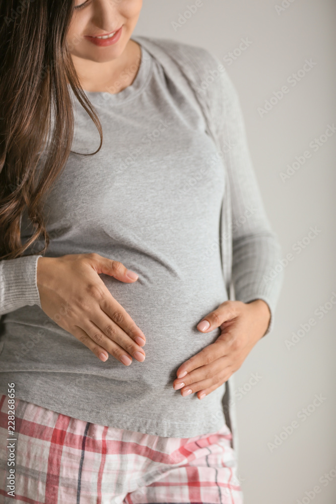 Beautiful pregnant woman on grey background Beautiful pregnant woman on grey background
