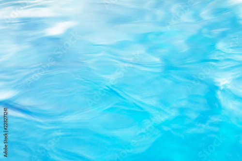 The smooth natural blue water background with bokeh  abstract on the sea or ocean,vintage and soft colored blur.