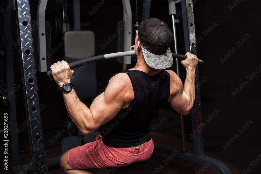Strong Bodybuilder Doing Heavy Weight Exercise For Back On Machine. Strong Bodybuilder Doing Heavy Weight Exercise For Back On Machine.