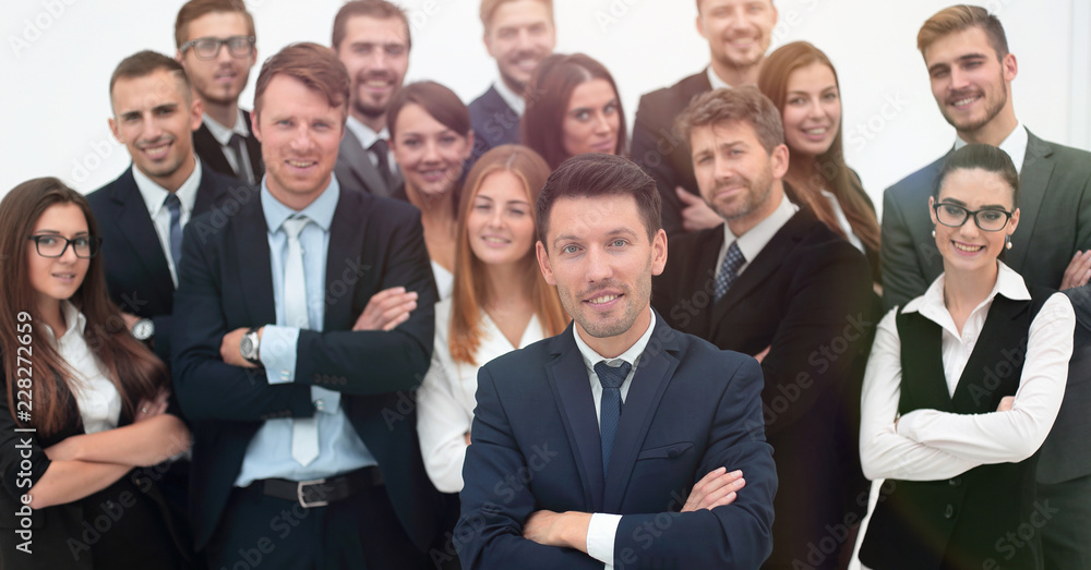 leader standing in front of a large business team leader standing in front of a large business team