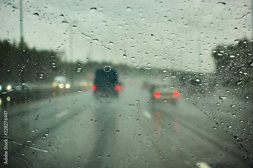 blurred view of road traffic on a rainy day through the car window