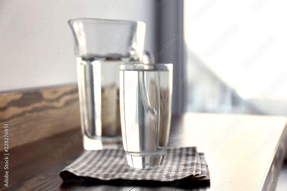 Glass and jug of cool clean water  on table
