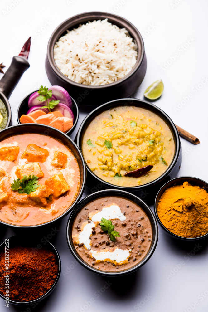 Indian Lunch / Dinner main course food in group includes Paneer Butter Masala, Dal Makhani, Palak Paneer, Roti, Rice etc, Selective focus Indian Lunch / Dinner main course food in group includes Paneer Butter Masala, Dal Makhani, Palak Paneer, Roti, Rice etc, Selective focus