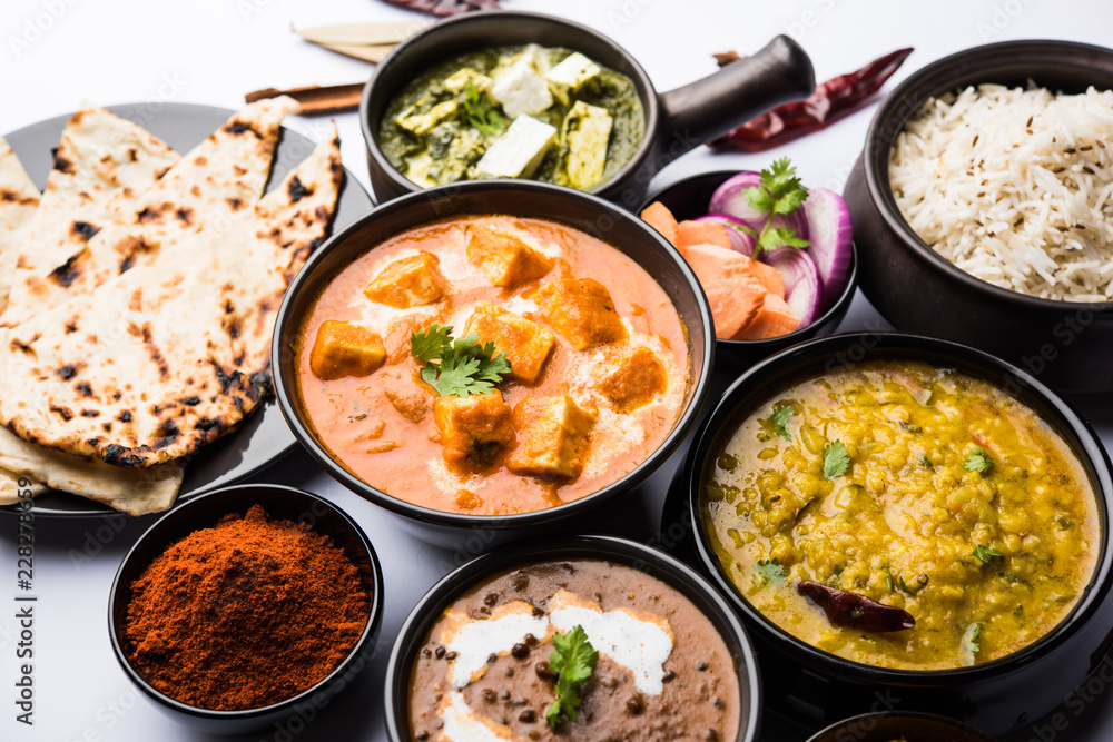 Indian Lunch / Dinner main course food in group includes Paneer Butter Masala, Dal Makhani, Palak Paneer, Roti, Rice etc, Selective focus Indian Lunch / Dinner main course food in group includes Paneer Butter Masala, Dal Makhani, Palak Paneer, Roti, Rice etc, Selective focus