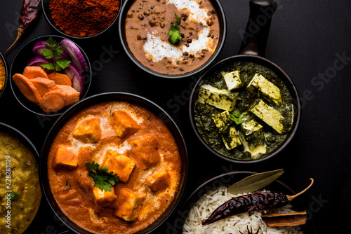 Indian Lunch / Dinner main course food in group includes Paneer Butter Masala, Dal Makhani, Palak Paneer, Roti, Rice etc, Selective focus