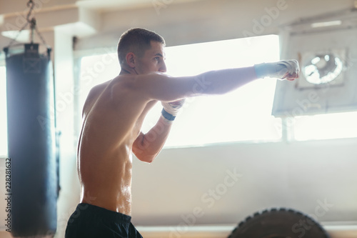 Male boxer during boxing exercise making direct hit