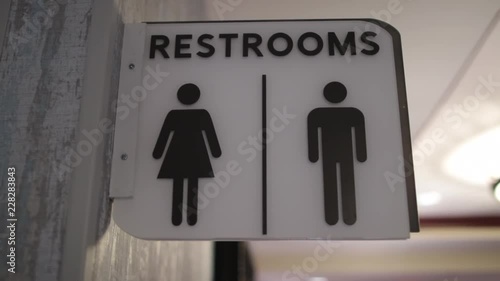 Restrooms sign white hanging icons close.mov