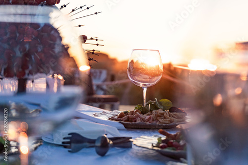 Couple enjoying wine against a beautiful sunset.
