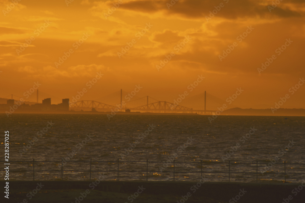 the four bridges in Edinburgh Scotland seen from Prestonpans at down sunset from the harbor travel concept