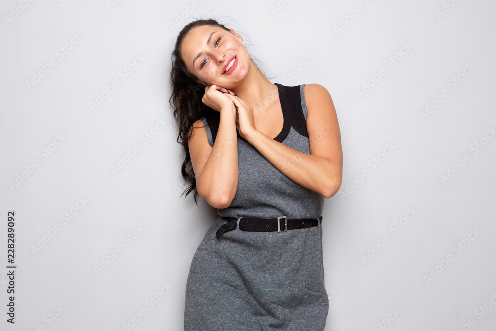 beautiful shy young woman standing with hands by face beautiful shy young woman standing with hands by face