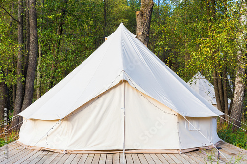 Canvas glamping tent at forest