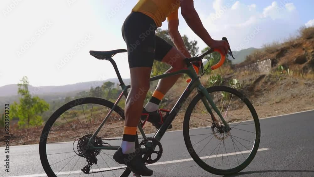 Man cycling on road bike outdoor exercise on an empty road in the morning .Extreme sport concept. Slow motion Man cycling on road bike outdoor exercise on an empty road in the morning .Extreme sport concept. Slow motion
