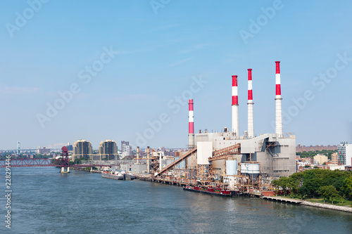 power plant beside river with blue sky