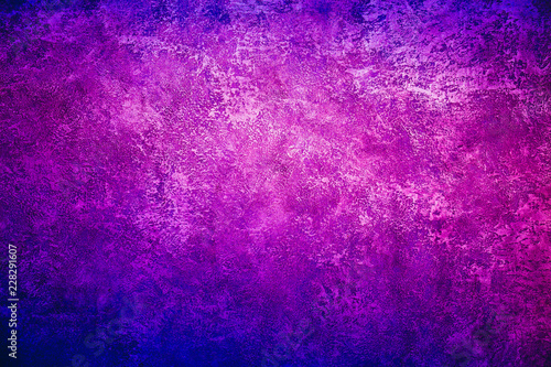 Texture background image of a wall with purple blue metallic shining plaster.