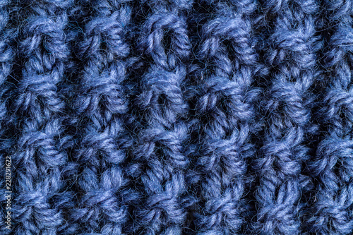 The texture of a blue knitted yarn. Knitted and winter clothes