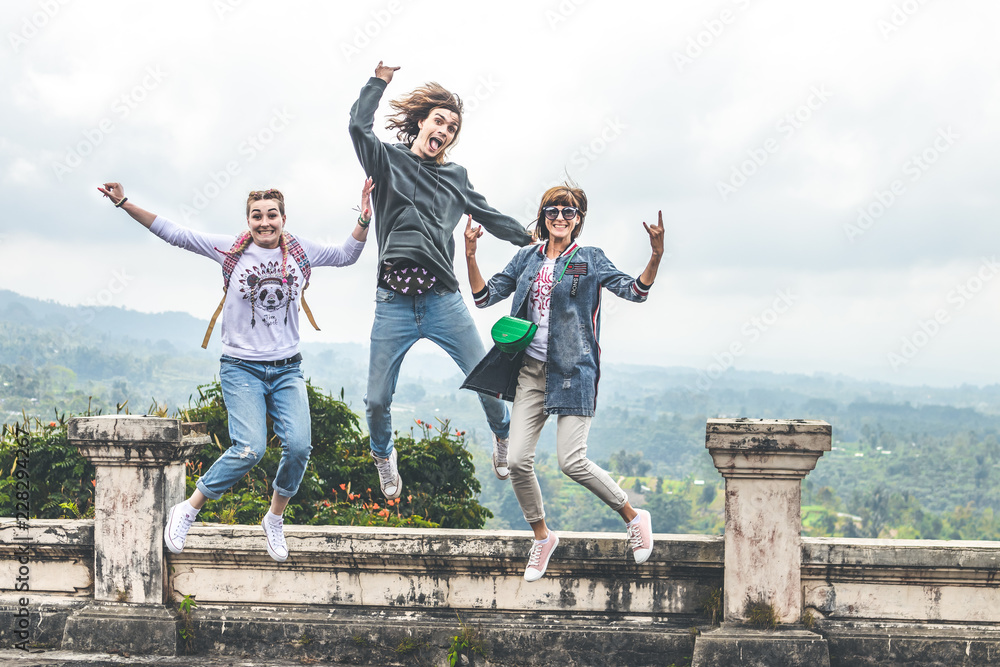 Three young tourists jumping in abandoned hotel on the north of Bali island, Indonesia. Three young tourists jumping in abandoned hotel on the north of Bali island, Indonesia.