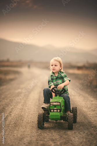 boy drives a toy tractor