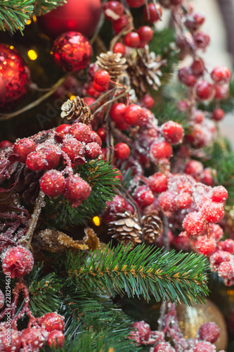 Christmas tree with red and golden flower decors interiors. Xmas. Close up.