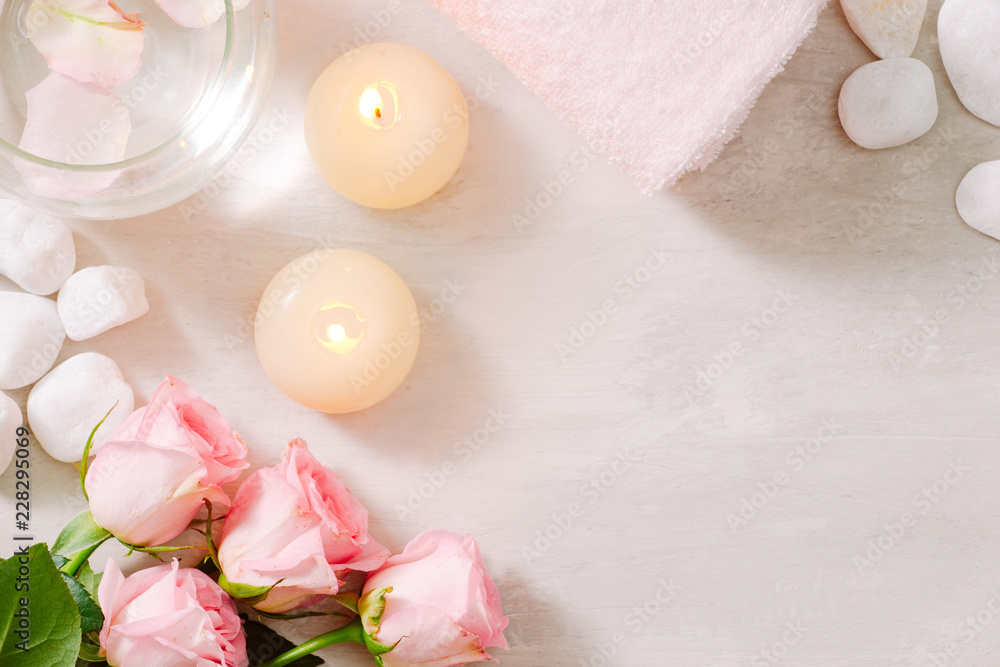 Spa settings with roses. Spa theme with candles and flowers on table. Spa settings with roses. Spa theme with candles and flowers on table.