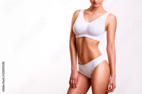 Woman beauty, body care. Slender line of a beauty young body in underwear.
