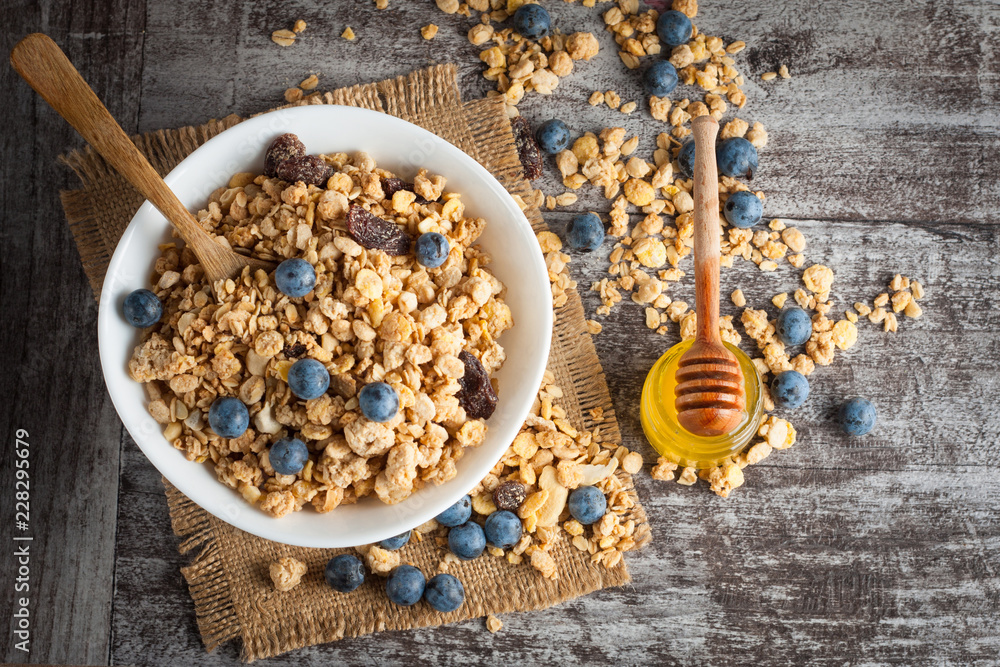 Healthy breakfast concept with oat flakes and fresh berries on rustic background. Food made of granola and muesli. Healthy banana smoothie with blackberries, honey and milk. Healthy breakfast concept with oat flakes and fresh berries on rustic background. Food made of granola and muesli. Healthy banana smoothie with blackberries, honey and milk.