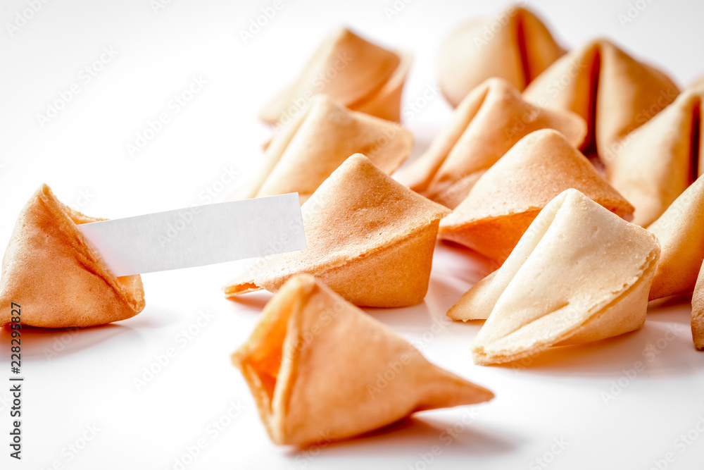 Chinese fortune cookie with prediction on white background Chinese fortune cookie with prediction on white background
