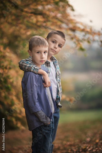 two boys are hugged