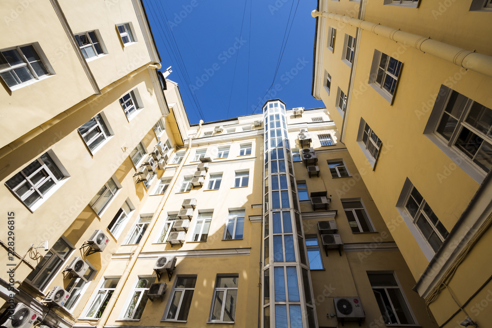 Fototapeta premium Yellow building wide angle view from down