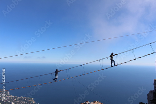 Father and son are on the suspension bridge at an altitude of 1234 meters