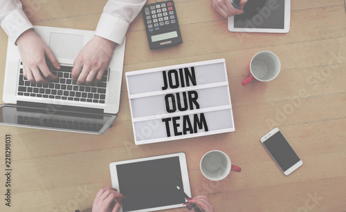 Join Our Team message in lightbox on office flat lay