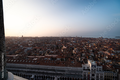 Venice city view from height. Houses roofs and sky at the sunset. Warm colors. Tilt-shift