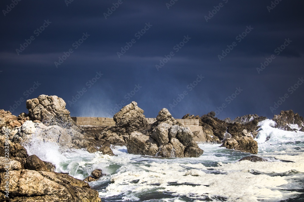 Dramatic big stormy crashing waves splash. Kleinmond, Western Cape, South Africa.