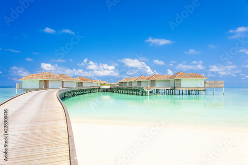 Tropical Water villas on Maldives island in the morning, holiday vacation background concept