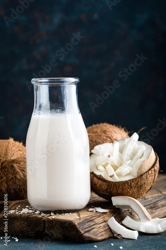 Fresh coconut milk in glass bottle, vegan non dairy healthy drink