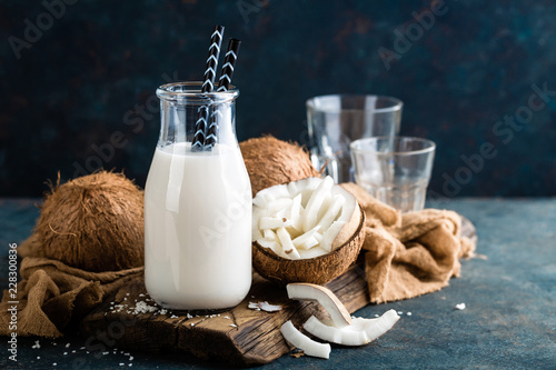 Fresh coconut milk in glass and bottle, vegan non dairy healthy drink