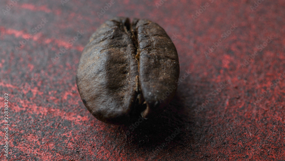 Naklejka premium coffee grain macro photo. on red stand