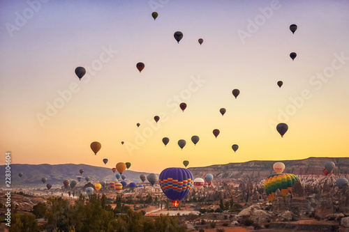 Hot air balloons taking off early in the morning at Goreme, Cappadocia.