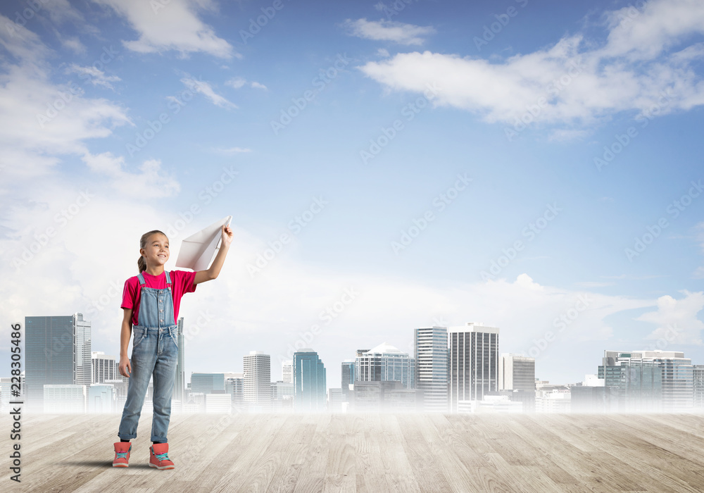 Concept of careless happy childhood with girl dreaming about future Concept of careless happy childhood with girl dreaming about future