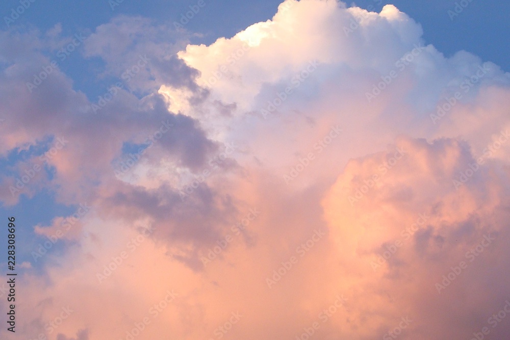 Clouds on the blue sky with pink tint