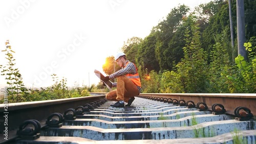 The railroad inspector checks the drawings and route map to identify gaps in the track