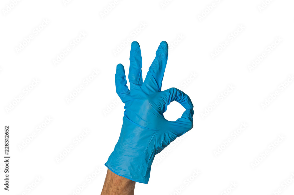 Human hand in blue rubber glove showing ok isolated on white background. Medical or cleaning concept Human hand in blue rubber glove showing ok isolated on white background. Medical or cleaning concept
