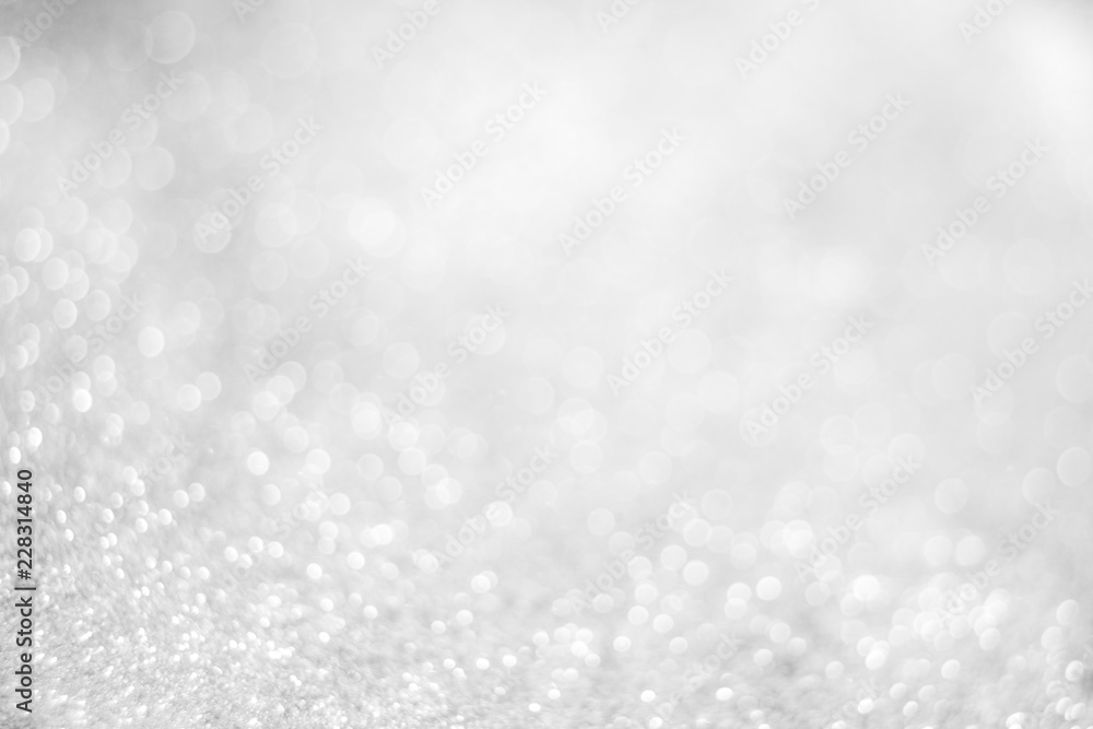 Abstract of Bright and sparkling bokeh background. silver and diamond dust bokeh blurred lighting from glitter texture Abstract of Bright and sparkling bokeh background. silver and diamond dust bokeh blurred lighting from glitter texture