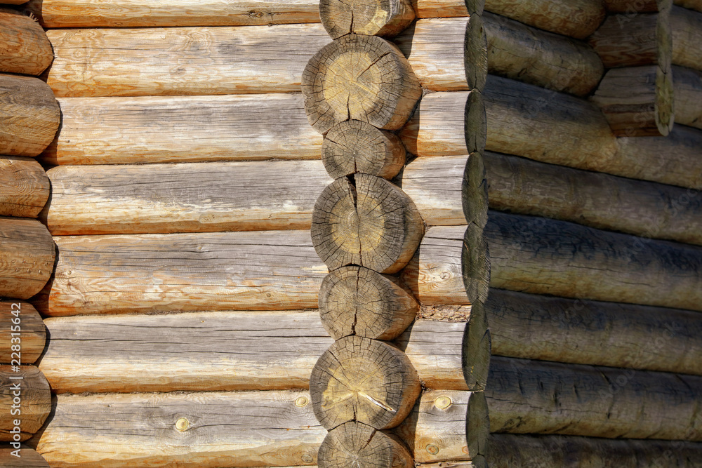 Wall with log house in the house as a background Wall with log house in the house as a background
